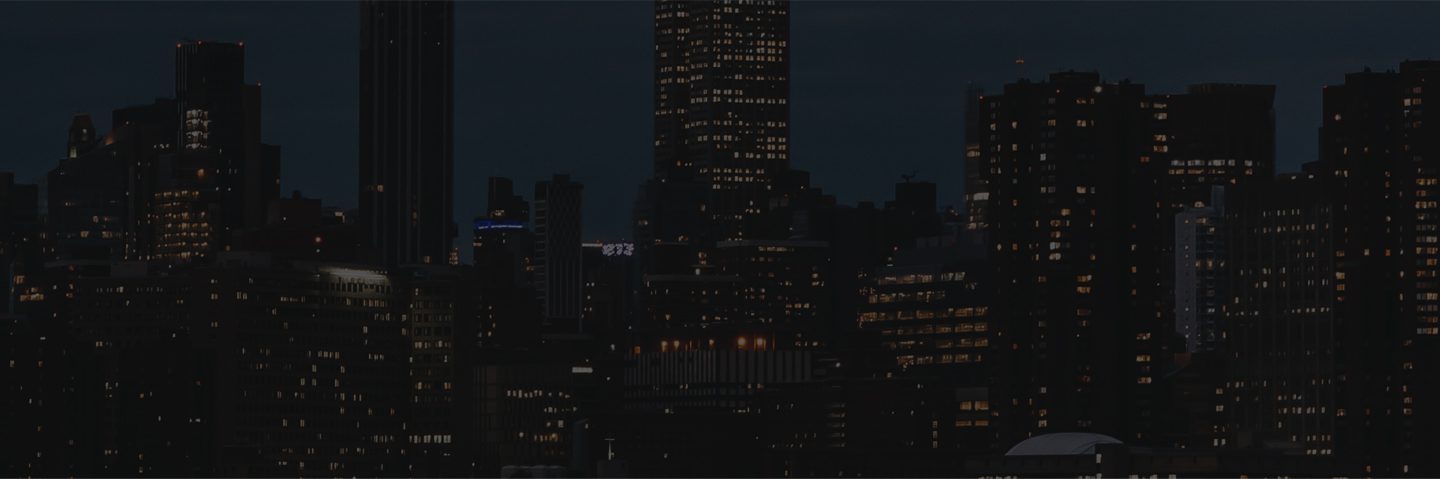 A city skyline at night with lights on.